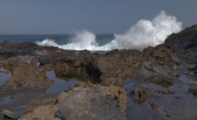Gran Canaria, north coast, rockpools around Puertillo de Banaderos area protected from the 
ocean waves by volcanic rock barrier