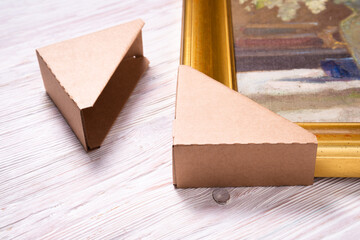 Brown cardboard carton picture frame corner protectors