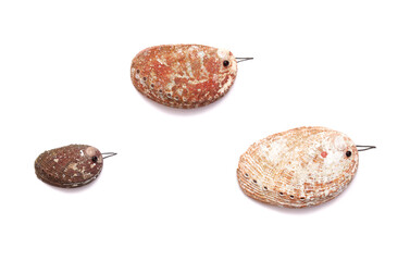 funny little birds made of a green ormer shell, with sketchily drawn legs and beak, 
and an eye made of a seed bead, isolated on white background