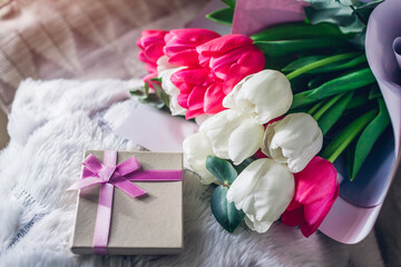 Bouquet of white and pink tulips with gift box at home. Spring flowers. Women's day. Present for Mother's day.