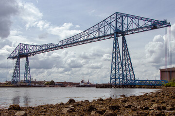 Blue steel Middlesborough Transporter Bridge from shore with clouds UK