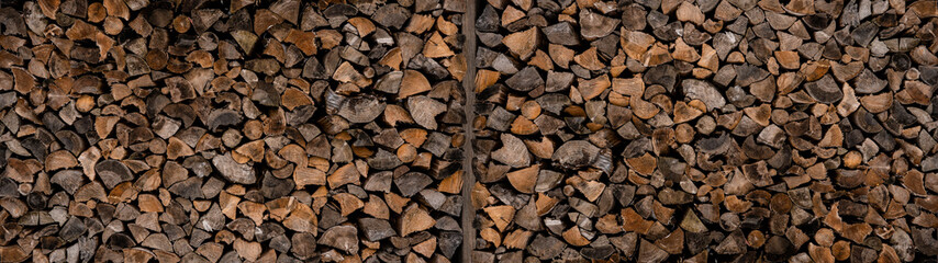 Forestry background - Forest pine and spruce trees. Log trunks pile, the logging timber wood industry.