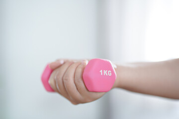 Overweight woman exercising for weight loss. exercise with dumbbells in stretching positions at home in the living room Cheerful&nbsp;Fat woman diet healthy lifestyle concept.