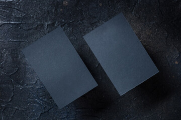 Black business card mock-up on a dark background, front and back, a template for design...