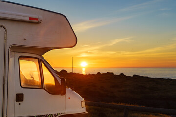 Camper car on beach at sunrise