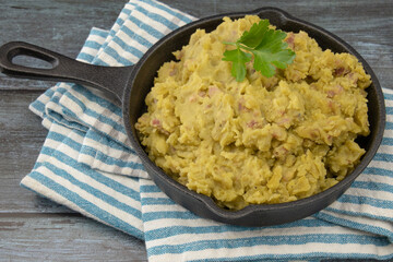 mashed split peas in a pan on a gray background