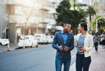These two go-getters stay on the move. Shot of two businesspeople having a discussion while walking...