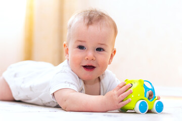 Cute little boy plaing with toys at home