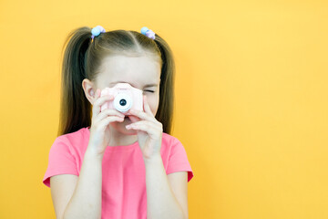 real happiness. hobby or career. beginner photographer with a camera. childhood. girl takes a picture. kid uses digital camera. happy baby photography.