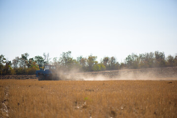 Fototapeta na wymiar Tractor plowing fields -preparing land for sowing