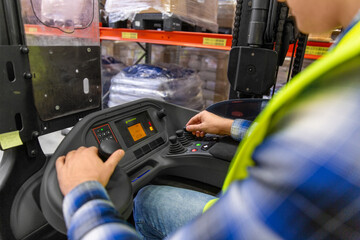 wholesale, logistic, loading, shipment and people concept - close up of man or worker operating forklift loader at warehouse © Syda Productions