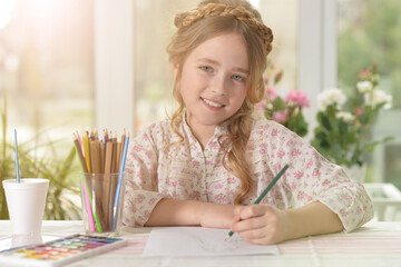cute little  girl drawing at home