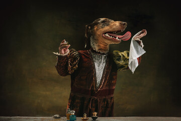 Perfumer. Model like medieval royalty person in vintage clothing headed by dog head isolated on dark vintage background. Concept of comparison of eras, artwork. Surrealism