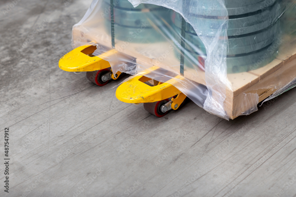 Wall mural logistic, shipment and industry concept - close up of loader with cargo on pallet at warehouse