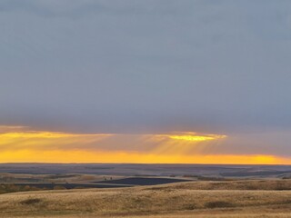Fototapeta na wymiar Minimalistic beautiful landscape with sunset or sunrise breaking through the clouds