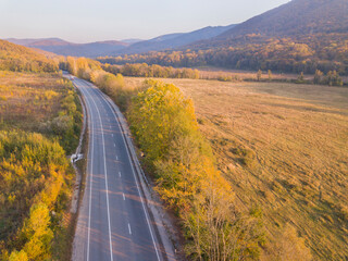 Aerial drone shot. Mountain road traffic. Russia.