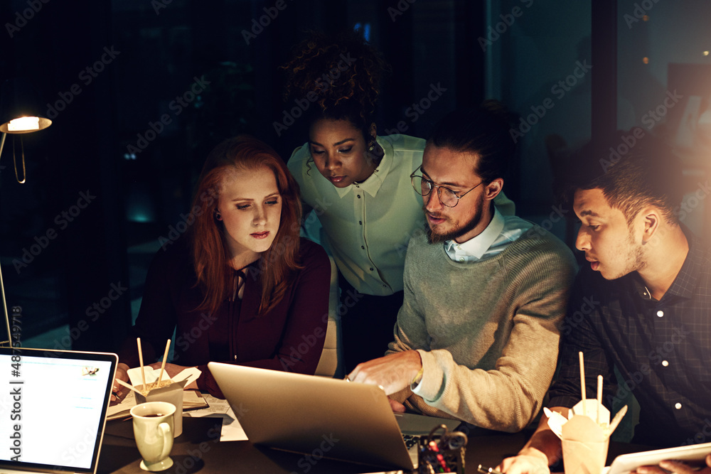 Poster were committed to completing prioritised tasks. cropped shot of a group of young people working late