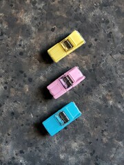 collage of colorful kid’s toy cars on the concrete background with copy space