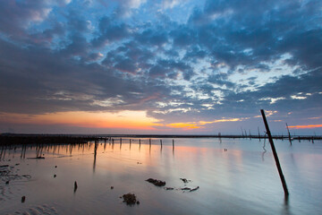 Beautiful landscape of sea level reflect fantasy dramatic sunset sky in wetlands , the famous travel attractions in Changhua Binhai Industrial Zone, Taiwan. (彰濱)