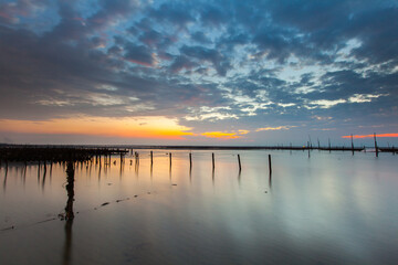 Beautiful landscape of sea level reflect fantasy dramatic sunset sky in wetlands , the famous travel attractions in Changhua Binhai Industrial Zone, Taiwan. (彰濱)