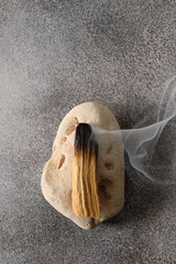 Palo Santo stick incense burning on stone. Spiritual practices for ritual cleansing, antistress,...