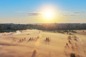 Morning view of a flat valley shrouded in mist in a nearby small town.