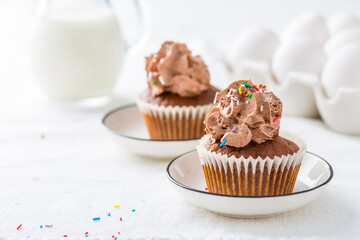 Homemade chocolate cupcakes with chocolate whipping cream