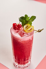 Cold alcoholic or non-alcoholic cocktail on pastel background. Hard light, deep shadow.