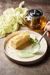 Piece of cake Napoleon puff pastry with custard cream. Russian cuisine, multi layered cake with...