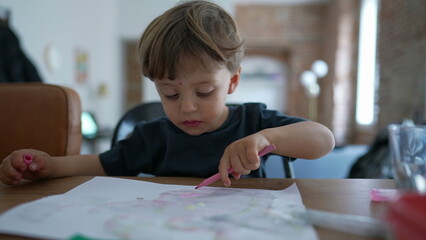 Child drawing with color pen on paper Little boy playing art and craft