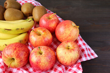 Heap of Assorted Fresh Ripe Fruits on Checkered Cloth for the Concept of EATING_WELL