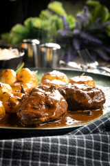 Traditional German braised pork cheeks in brown sauce.