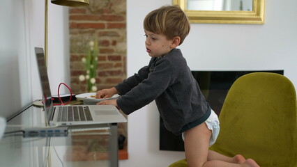 Baby boy wearing diapers in front of laptop at home 2 year old toddler