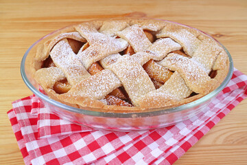 Tasty and healthy  fresh baked homemade apple pie on wooden table