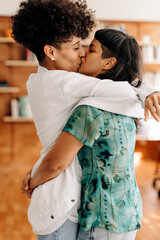 Cute lesbian couple kissing indoors