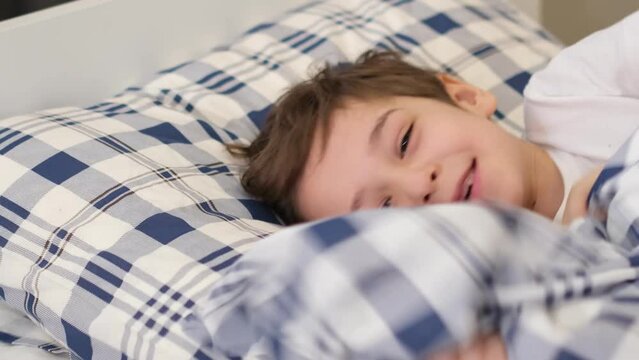 child was lying on the bed in a good mood, the child recovered from the illness and felt good
