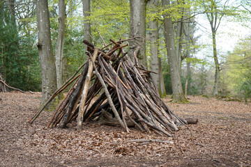 Camp in the woods made of logs and sticks