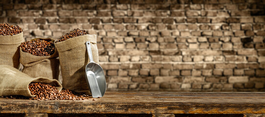 Fresh coffee beans in sack and dark interior with shadows.  - obrazy, fototapety, plakaty