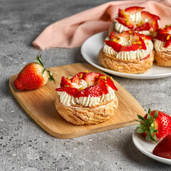 Choux pastries. Craquelin Choux biscuits. crispy cream puffs with cream filling and Strawberries