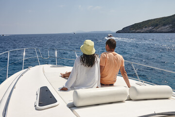 Young couple resting on a yacht in the sea in Zakynthos