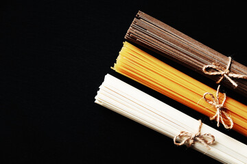 Noodles from different countries. Soba, udon, spaghetti.
