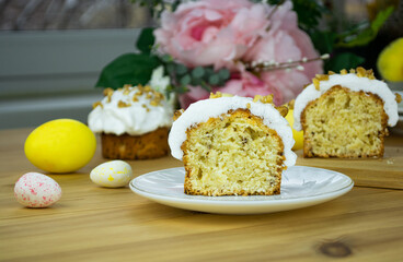 A piece of Easter Orthodox sweet bread, a cake and decorative egg candies. Close-up, selective focus.