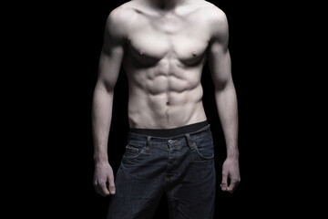 Fototapeta na wymiar Sexy man body with six pack abs isolated on black