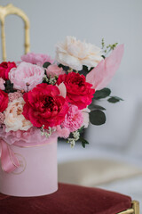 Bouquet of pink peonies a girl for mother's day, valentine's day, Woman's day 8 march. White interior.