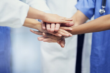 Saving lives together. Closeup shot of a group of medical professionals standing in a huddle with...