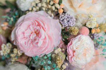 Beautiful spring flowers in box of tender peonies, roses and Gypsophila flowers. Preserved flowers for womens.