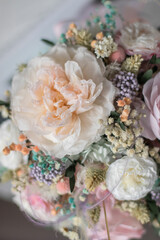 Beautiful spring flowers in box of tender peonies, roses and Gypsophila flowers. Preserved flowers for womens.
