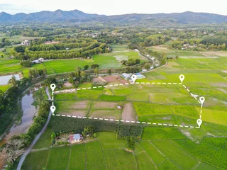 Foto op Canvas Land plot in aerial view, Top view land green field agriculture plant with pins, pin location icon for housing subdivision residential development owned sale rent buy or investment countryside suburbs © Bigc Studio