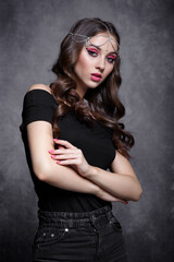 Beauty portrait of young woman. Brunette girl with evening female makeup and black T-shirt