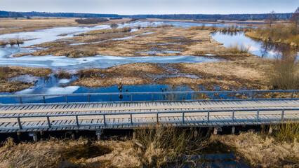 The top view on flood of the river, bridge and forest. High water at early spring.